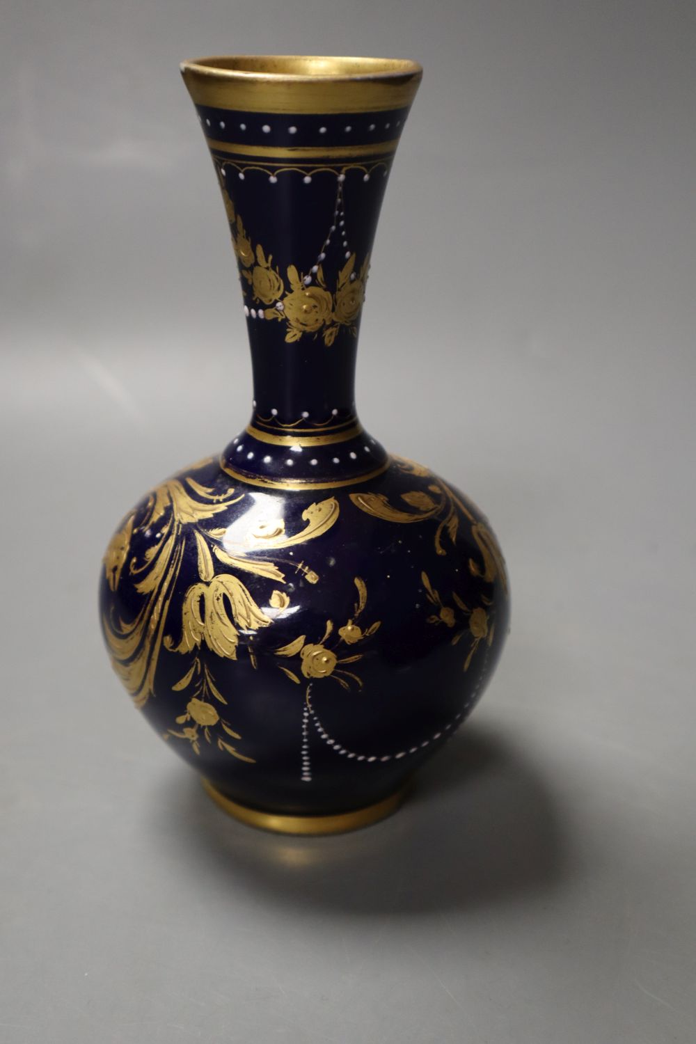 A Vienna vase painted with a woman and children on a blue and gilt ground, 14cm